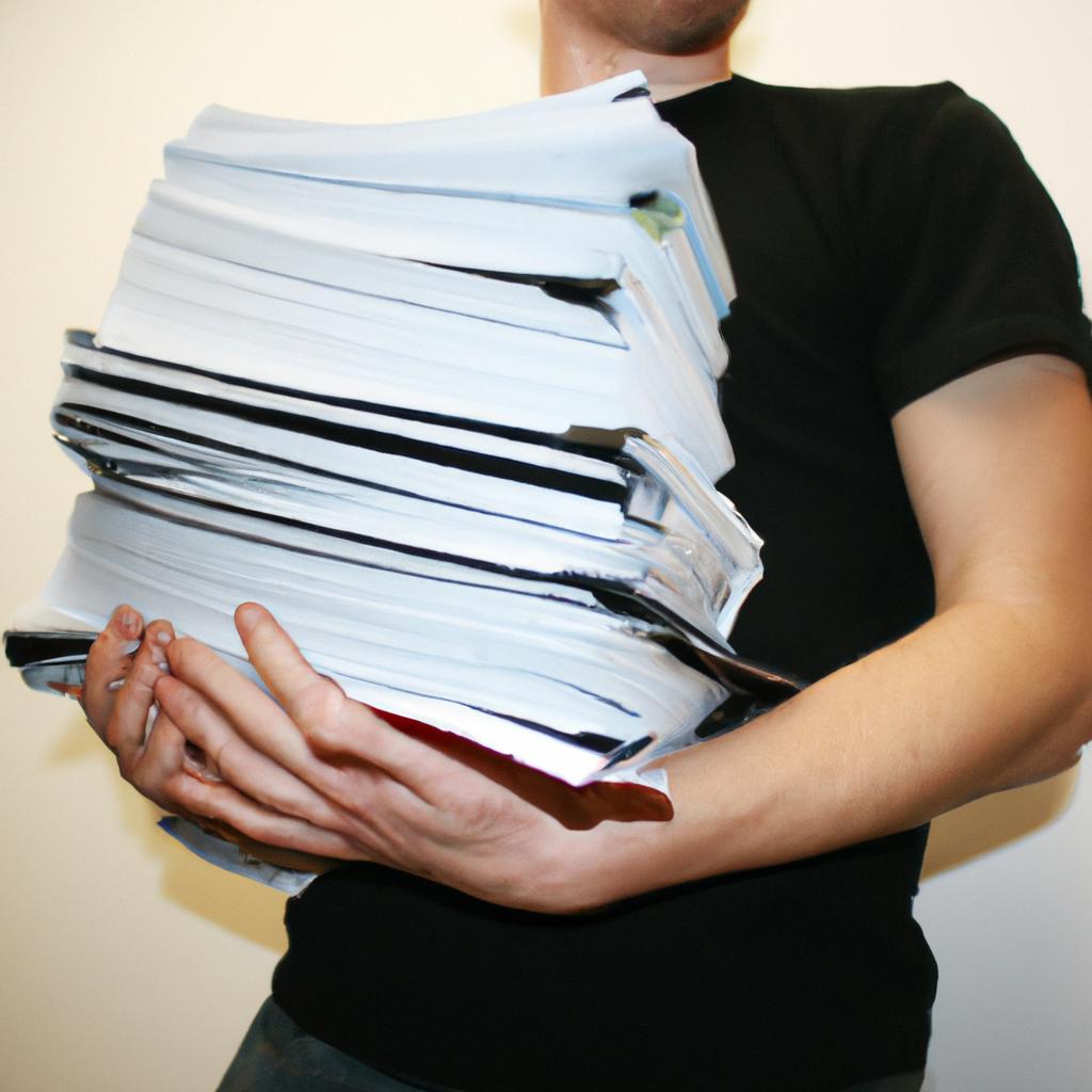 Man holding stack of papers